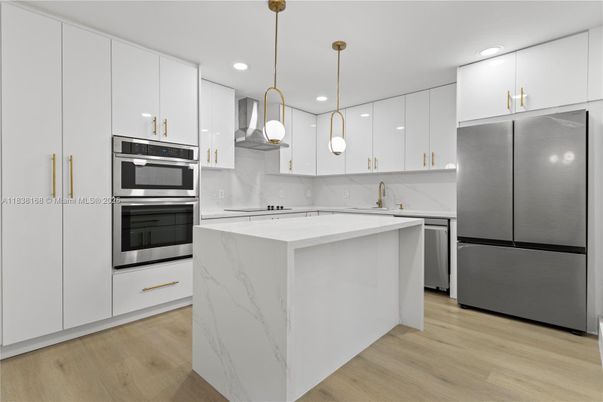 Interior, Kitchen, Marble Walls, Pendant Lights, Recessed Lighting, Stainless Steel Appliances, Wood Texture Flooring