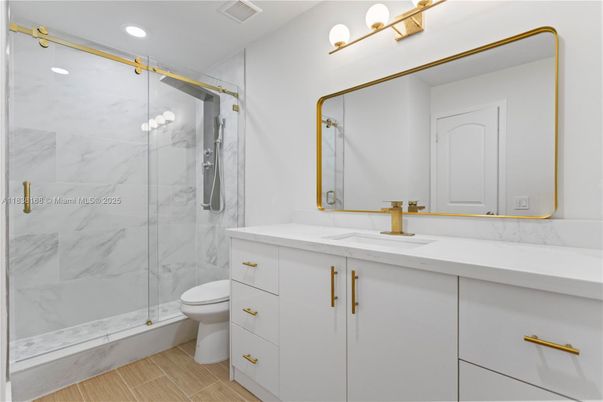 Bathroom, Dual Sink Vanities, Glass Shower, Interior, Marble Walls, Recessed Lighting, Wood Texture Flooring