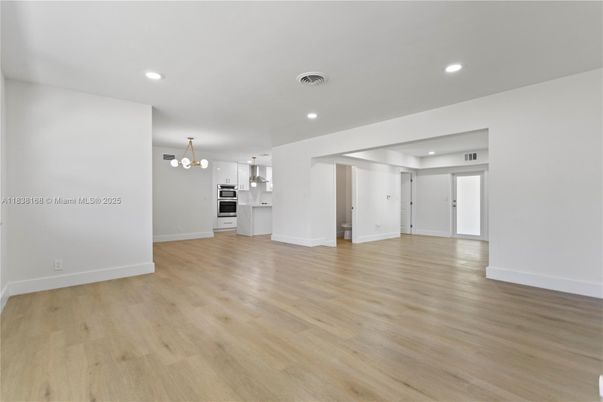 Empty room, Interior, Kitchen, Pendant Lights, Recessed Lighting, Stainless Steel Appliances, Wood Texture Flooring