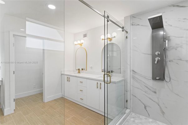 Bathroom, Dual Sink Vanities, Glass Shower, Interior, Marble Walls, Recessed Lighting, Wood Texture Flooring