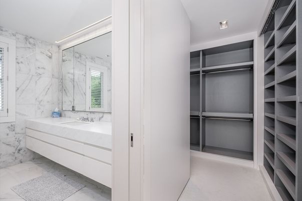 Bathroom, Dual Sink Vanities, Interior, Marble, Marble Walls, Recessed Lighting, Walk-in Closets