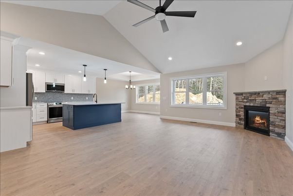 Empty room, Fireplace, Interior, Kitchen, Pendant Lights, Recessed Lighting, Stainless Steel Appliances, Wood Texture Flooring