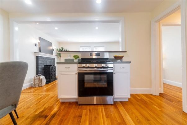 Fireplace, Interior, Kitchen, Recessed Lighting, Stainless Steel Appliances, Wood Texture Flooring