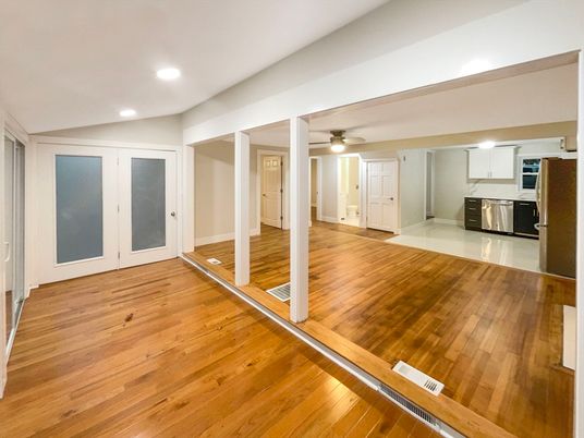 Empty room, Interior, Kitchen, Recessed Lighting, Stainless Steel Appliances, Wood Texture Flooring