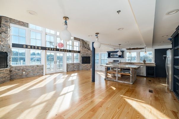 Fireplace, Interior, Kitchen, Pendant Lights, Recessed Lighting, Stainless Steel Appliances, Stone Walls, Wood Texture Flooring