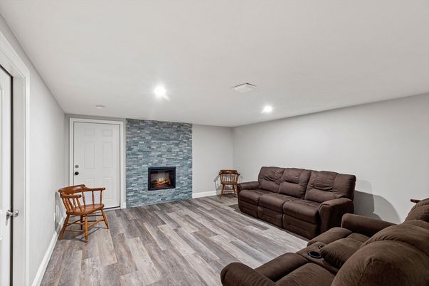 Fireplace, Interior, Living room, Recessed Lighting, Stone Walls, Wood Texture Flooring