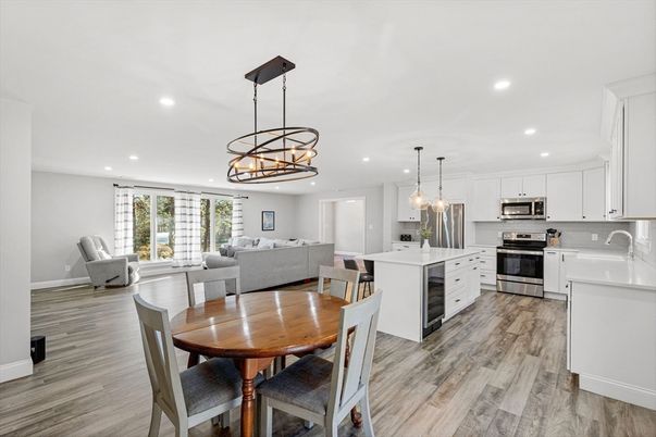 Chandelier, Dining room, Interior, Kitchen, Living room, Pendant Lights, Recessed Lighting, Stainless Steel Appliances, Wood Texture Flooring