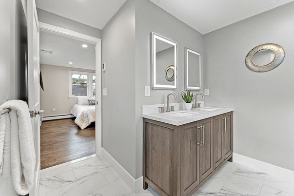 Bathroom, Dual Sink Vanities, Interior, Marble, Recessed Lighting, Wood Texture Flooring
