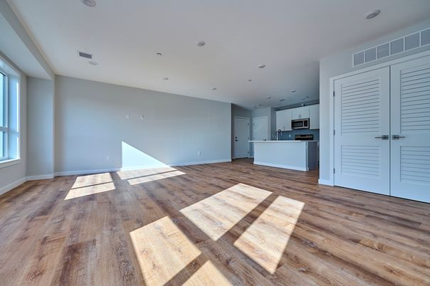 Empty room, Interior, Kitchen, Recessed Lighting, Stainless Steel Appliances, Wood Texture Flooring