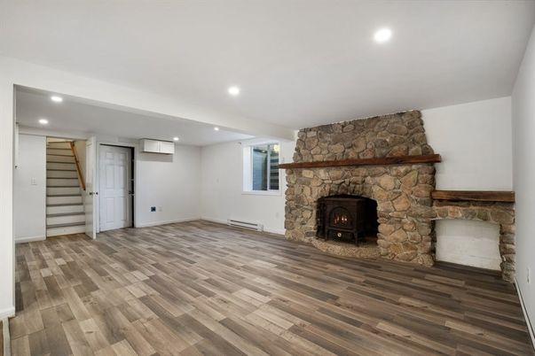 Empty room, Fireplace, Interior, Recessed Lighting, Stone Walls, Wood Texture Flooring