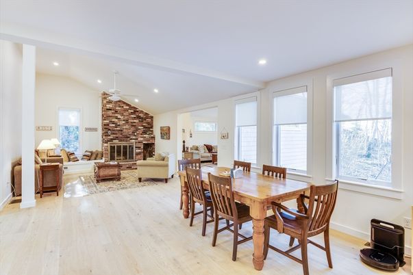 Dining room, Fireplace, Interior, Living room, Recessed Lighting, Stone Walls, Wood Texture Flooring