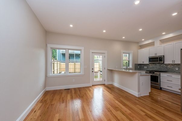 Empty room, Interior, Kitchen, Recessed Lighting, Stainless Steel Appliances, Wood Texture Flooring
