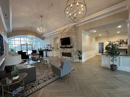 Chandelier, Fireplace, Interior, Living room, Pendant Lights, Recessed Lighting, Stone Walls, Wood Texture Flooring