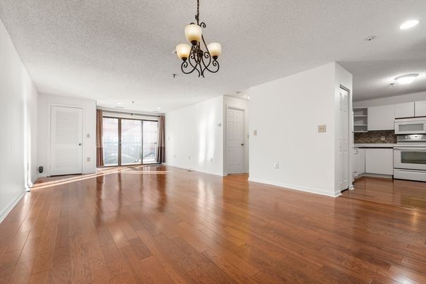 Chandelier, Empty room, Interior, Kitchen, Recessed Lighting, Stainless Steel Appliances, Wood Texture Flooring