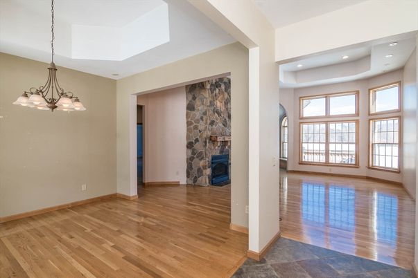 Chandelier, Empty room, Fireplace, Interior, Recessed Lighting, Stone Walls, Wood Texture Flooring