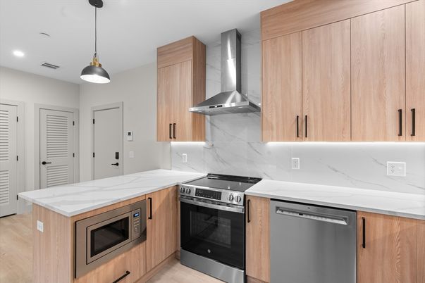 Interior, Kitchen, Marble Walls, Pendant Lights, Recessed Lighting, Stainless Steel Appliances, Wood Texture Flooring