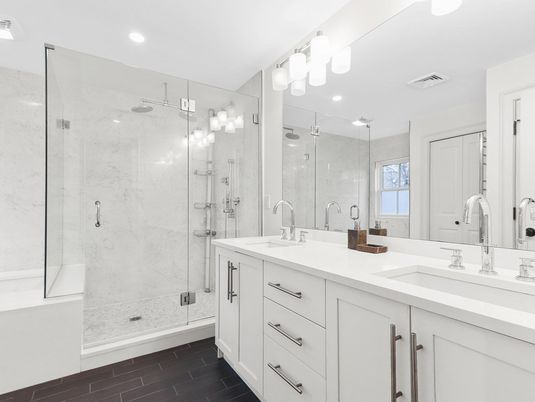 Bathroom, Dual Sink Vanities, Glass Shower, Interior, Marble Walls, Recessed Lighting, Wood Texture Flooring