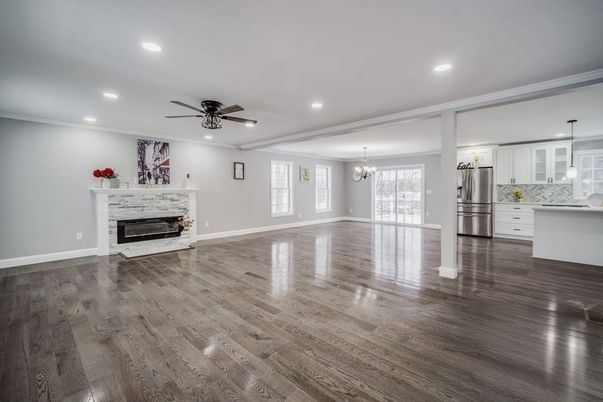 Chandelier, Empty room, Fireplace, Interior, Kitchen, Recessed Lighting, Stainless Steel Appliances, Wood Texture Flooring