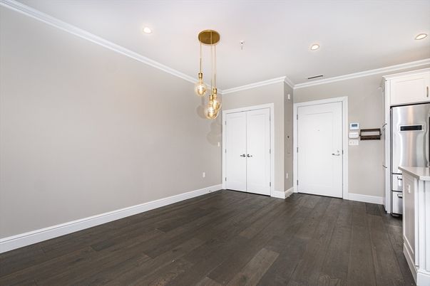 Empty room, Interior, Kitchen, Pendant Lights, Recessed Lighting, Stainless Steel Appliances, Wood Texture Flooring