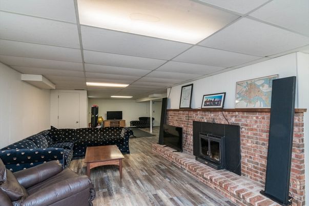 Fireplace, Interior, Living room, Recessed Lighting, Stone Walls, Wood Texture Flooring