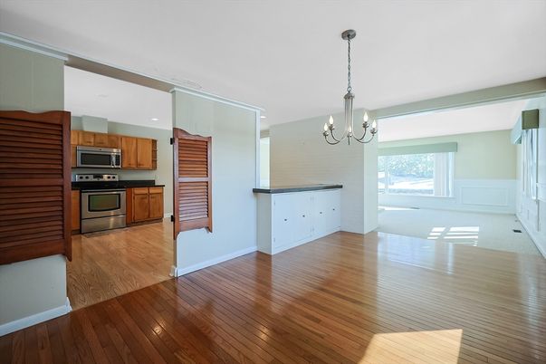 Chandelier, Empty room, Interior, Kitchen, Recessed Lighting, Stainless Steel Appliances, Wood Texture Flooring