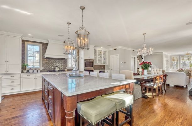 Chandelier, Dining room, Interior, Kitchen, Living room, Pendant Lights, Recessed Lighting, Stainless Steel Appliances, Wood Texture Flooring