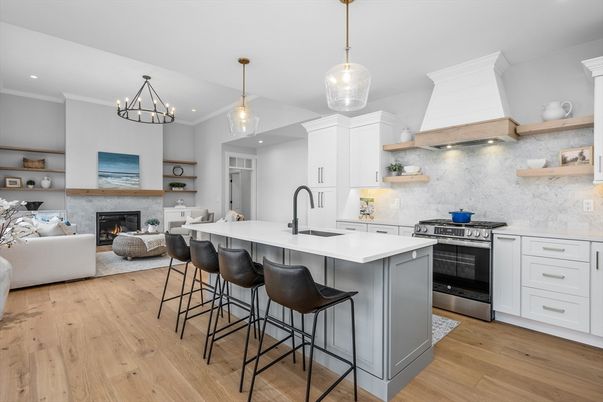 Chandelier, Fireplace, Interior, Kitchen, Living room, Pendant Lights, Recessed Lighting, Stainless Steel Appliances, Wood Texture Flooring