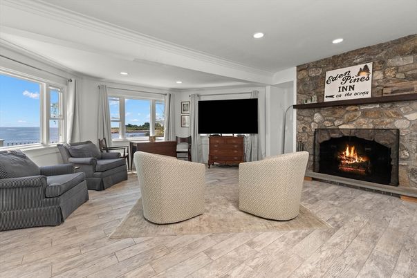 Fireplace, Interior, Living room, Recessed Lighting, Stone Walls, Water, Wood Texture Flooring