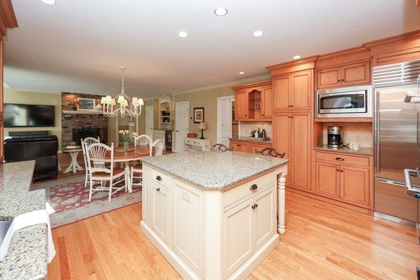 Chandelier, Dining room, Fireplace, Interior, Kitchen, Recessed Lighting, Stainless Steel Appliances, Stone Walls, Wood Texture Flooring