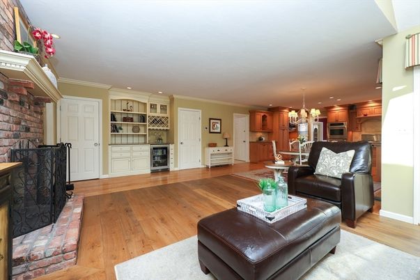 Chandelier, Fireplace, Interior, Kitchen, Living room, Recessed Lighting, Stainless Steel Appliances, Stone Walls, Wood Texture Flooring
