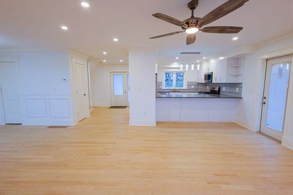 Empty room, Interior, Kitchen, Recessed Lighting, Stainless Steel Appliances, Wood Texture Flooring
