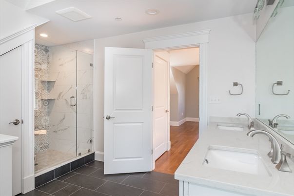 Bathroom, Dual Sink Vanities, Glass Shower, Interior, Marble Walls, Recessed Lighting, Wood Texture Flooring