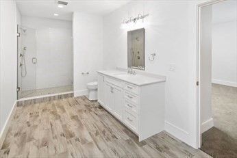 Bathroom, Dual Sink Vanities, Glass Shower, Interior, Recessed Lighting, Wood Texture Flooring