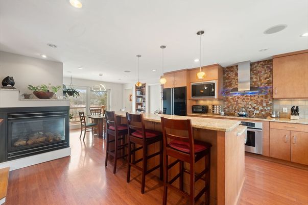 Dining room, Fireplace, Interior, Kitchen, Pendant Lights, Recessed Lighting, Stainless Steel Appliances, Wood Texture Flooring