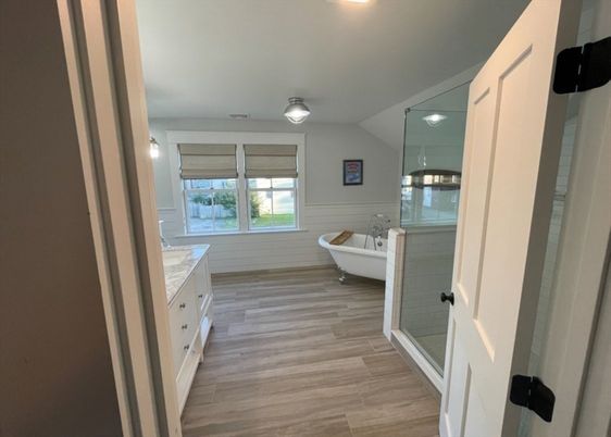 Bathroom, Free Standing Baths, Glass Shower, Interior, Recessed Lighting, Wood Texture Flooring