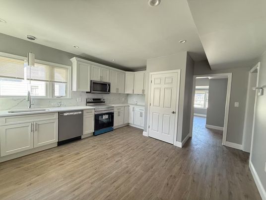 Interior, Kitchen, Marble Walls, Recessed Lighting, Stainless Steel Appliances, Wood Texture Flooring