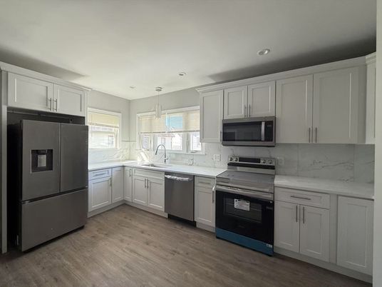 Interior, Kitchen, Marble Walls, Pendant Lights, Recessed Lighting, Stainless Steel Appliances, Wood Texture Flooring