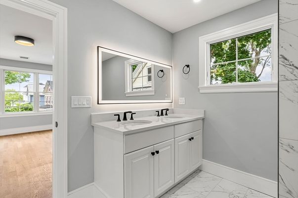 Bathroom, Dual Sink Vanities, Interior, Marble, Marble Walls, Recessed Lighting, Wood Texture Flooring