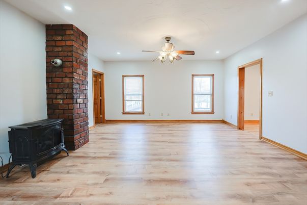 Empty room, Fireplace, Interior, Recessed Lighting, Stone Walls, Wood Texture Flooring