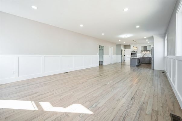 Empty room, Interior, Kitchen, Pendant Lights, Recessed Lighting, Stainless Steel Appliances, Wood Texture Flooring