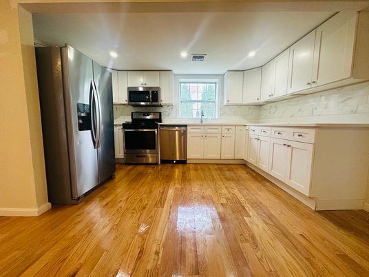 Interior, Kitchen, Marble Walls, Recessed Lighting, Stainless Steel Appliances, Wood Texture Flooring