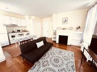 Fireplace, Interior, Kitchen, Living room, Recessed Lighting, Stainless Steel Appliances, Wood Texture Flooring