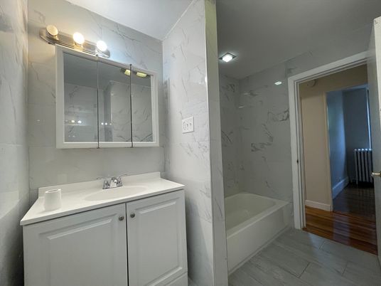 Bathroom, Glass Shower, Interior, Marble Walls, Wood Texture Flooring