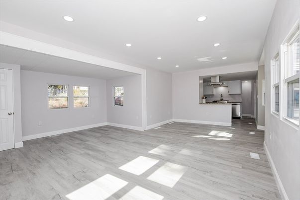 Empty room, Interior, Kitchen, Recessed Lighting, Stainless Steel Appliances, Wood Texture Flooring