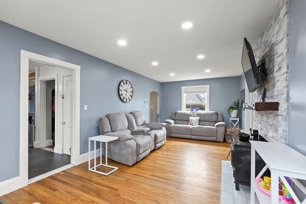 Fireplace, Interior, Living room, Recessed Lighting, Stone Walls, Wood Texture Flooring