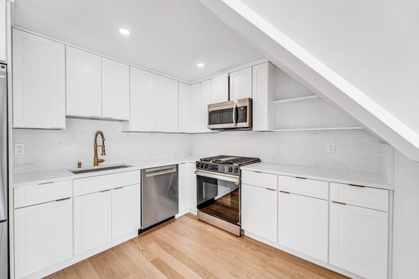 Interior, Kitchen, Marble Walls, Recessed Lighting, Stainless Steel Appliances, Wood Texture Flooring