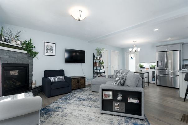 Chandelier, Fireplace, Interior, Kitchen, Living room, Recessed Lighting, Stainless Steel Appliances, Wood Texture Flooring