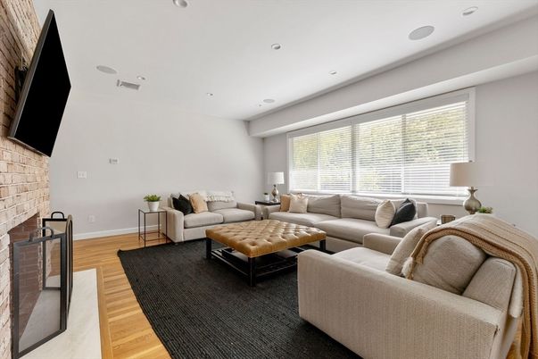 Fireplace, Interior, Living room, Recessed Lighting, Stone Walls, Wood Texture Flooring