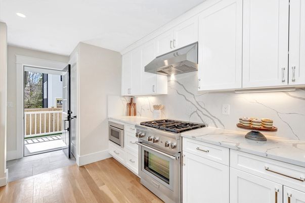Interior, Kitchen, Marble Walls, Recessed Lighting, Stainless Steel Appliances, Wood Texture Flooring