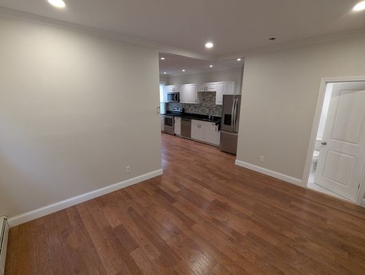 Empty room, Interior, Kitchen, Recessed Lighting, Stainless Steel Appliances, Wood Texture Flooring